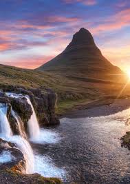 waterfalls with mountain in background